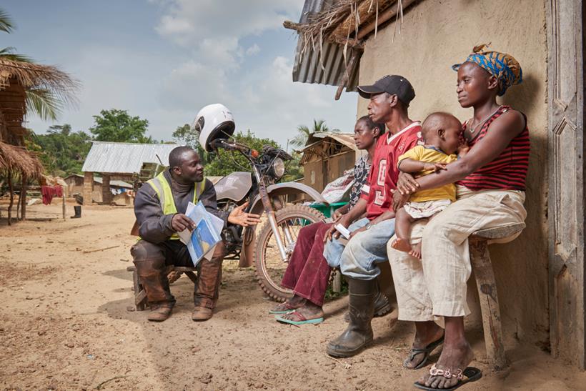 Riders for Health aid worker with a family