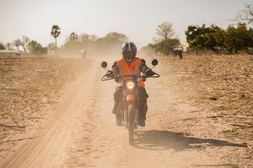 Riders for Health rider on sand road