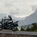 2025-on Kawasaki Versys 1100 SE riding with a mountain back drop