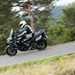 2025-on Kawasaki Versys 1100 SE riding through a forest