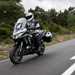 2025-on Kawasaki Versys 1100 SE touring down a tree lined road