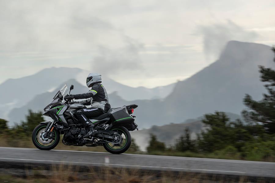 2025-on Kawasaki Versys 1100 SE riding with a mountain back drop