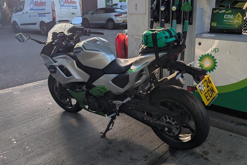 Kawasaki Ninja 7 Hybrid brimmed with fuel on a petrol station forecourt