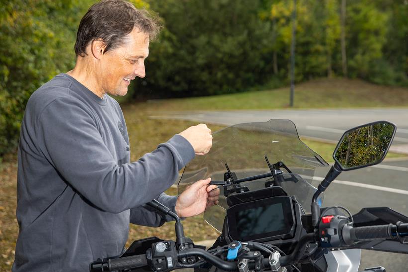 Michael Guy adjusts the Suzuki GSX-S1000GX's aftermarket screen