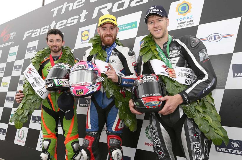 Lee Johnston (East Coast Construction Triumph) celebrates winning the second Supersport race at the Ulster Grand Prix with runner up Glenn Irwin (Gearlink Kawasaki) and third placed Ian Hutchinson (TTC Yamaha).