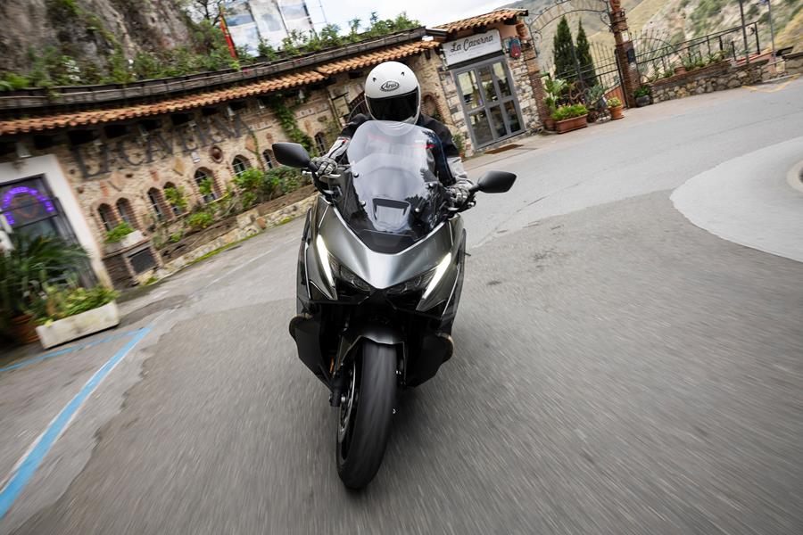 Honda Forza 750 ridden in front of a restaurant