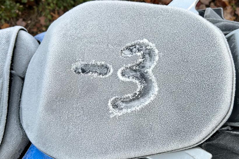 A motorcycle seat, with '-3' drawn out in the frost