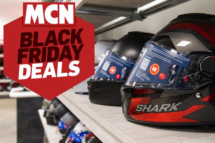 Motorcycle helmets o the shelf, with MCN's Black Friday Deals logo