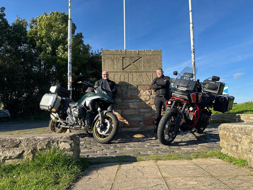 Motorcycle riders stood with the Scotland sign