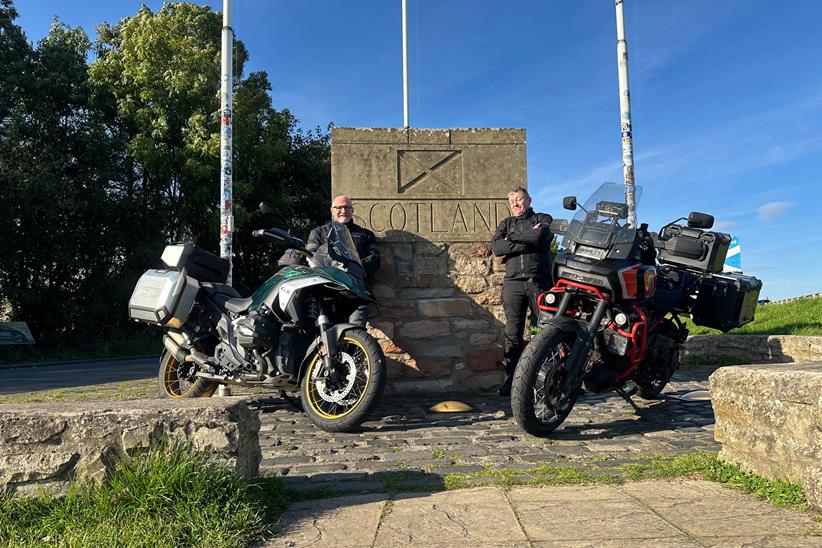 Motorcycle riders stood with the Scotland sign