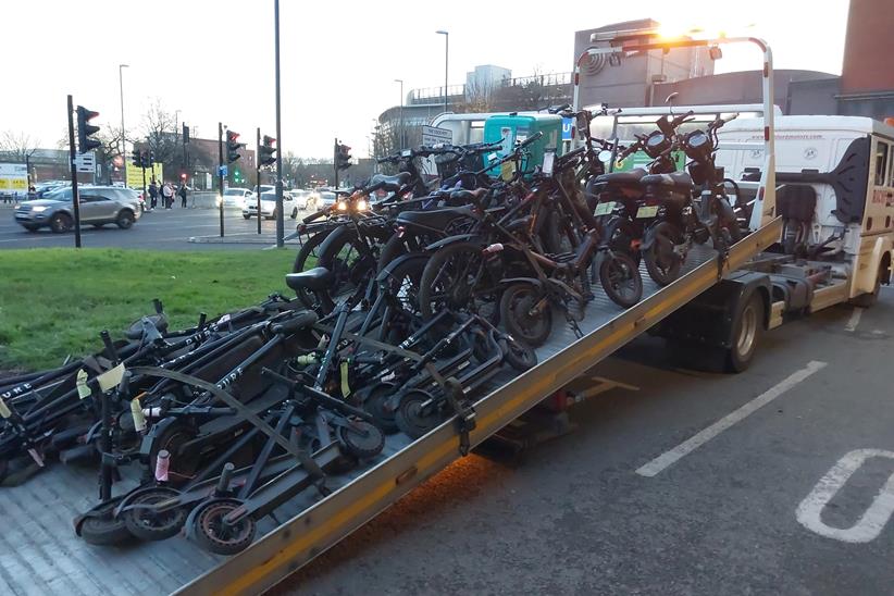 A recovery lorry loaded with seized e-bikes