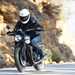 2025-on Triumph Speed Twin 900 riding past a rocky back drop