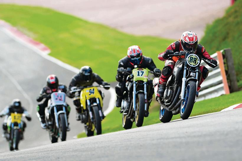 Group of racers on track aboard Honda CB500s