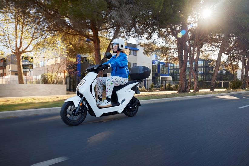 Honda EM1 e being ridden on a road