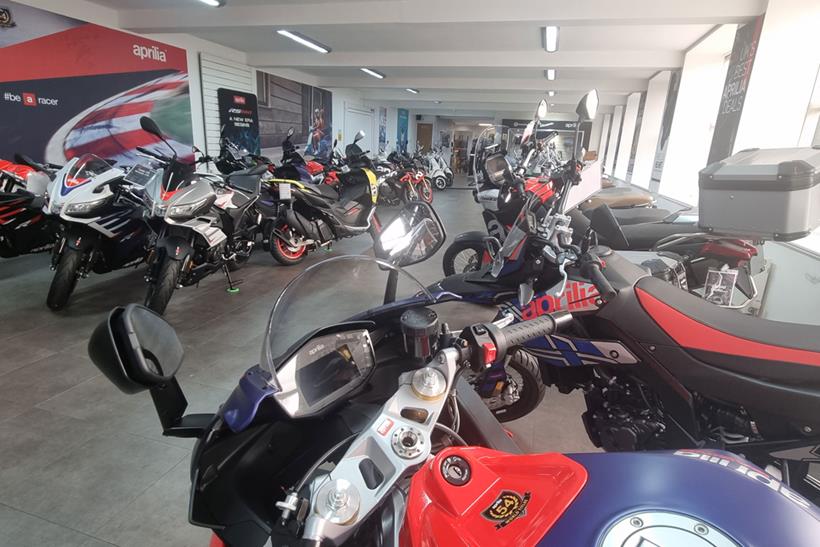 Cockpit view of an Aprilia RS660 inside a showroom