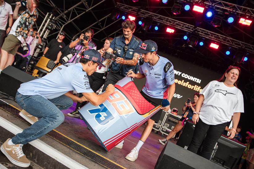 The Marquez brothers sign memorabilia on stage