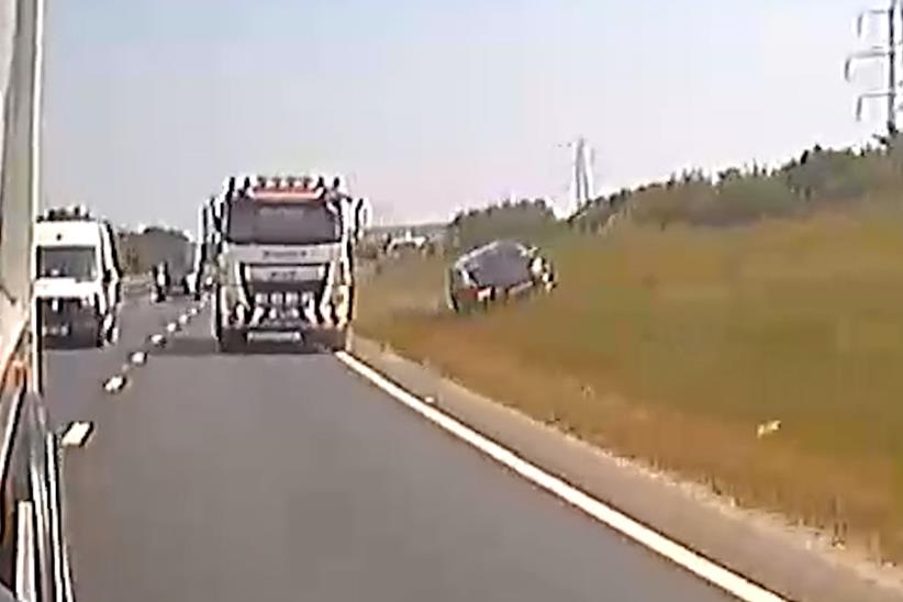 Une voiture entreprend un camion sur le bord de l'herbe