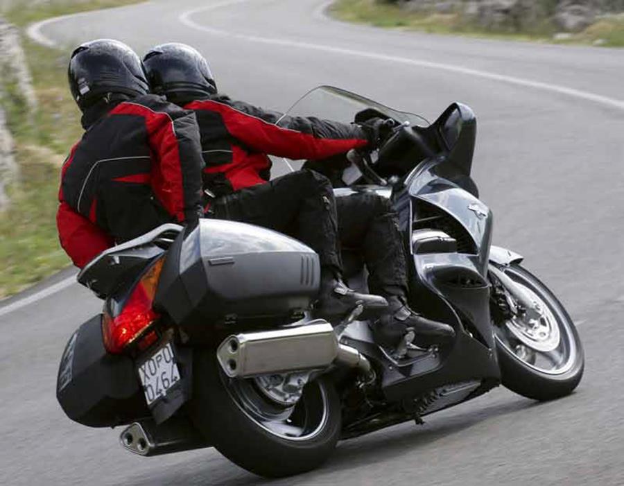 Honda Pan European ridden quickly around a bend with two on the bike