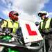 A motorcyclist speaks with their instructor