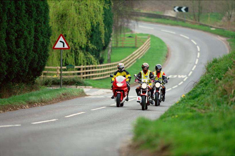 A group of motorcyclists under instruction