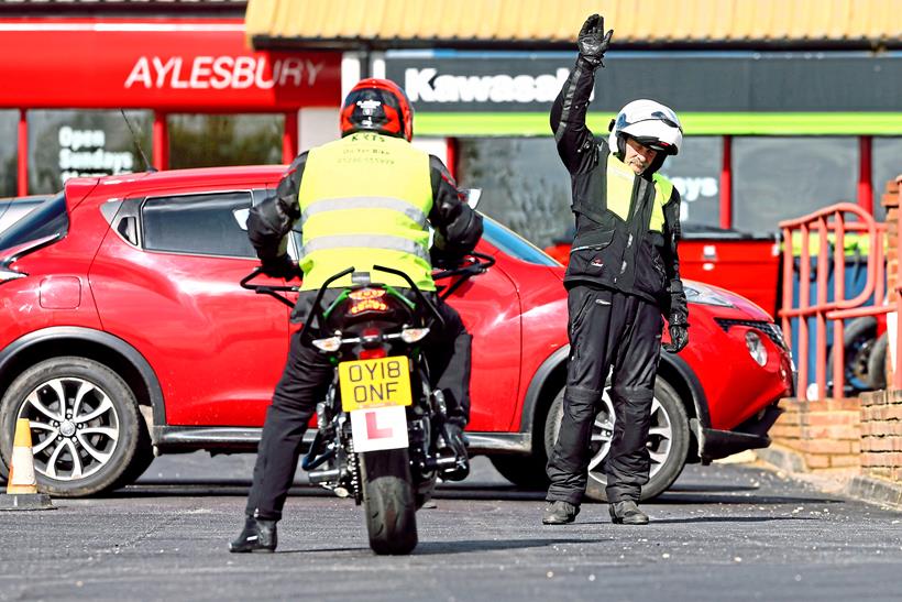 A Kawasaki rider prepares for his motorcycle test