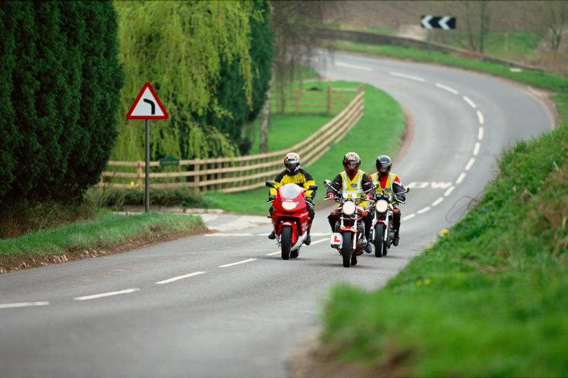 A group of motorcyclists under instruction