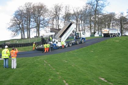 Workmen lay the new surface at Cadwell Park