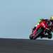 2025-on Ducati Panigale V2 S cresting a hill leaning into a corner on track