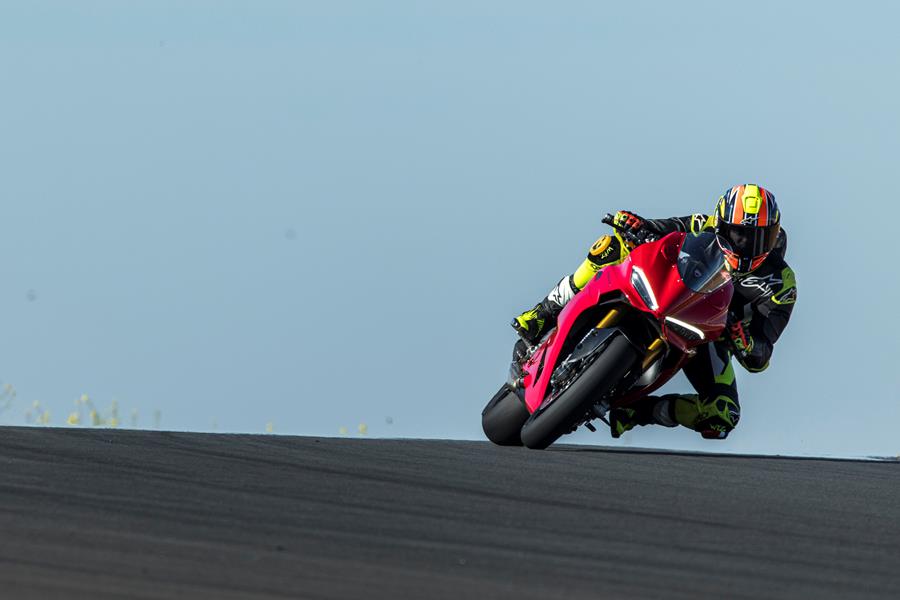 2025-on Ducati Panigale V2 S cresting a hill leaning into a corner on track