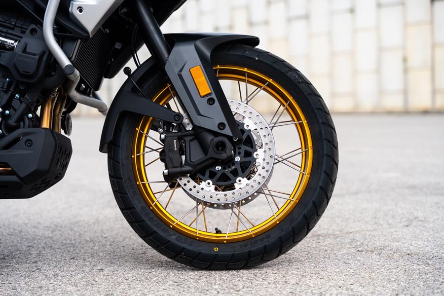 2025-on CF Moto 700MT - detailed shot of the front brakes and gold wheel rim