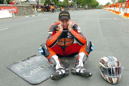 Disappointed - John McGuinness' face says it all as race one is cancelled due to bad weather (Pic: Pacemaker Press)