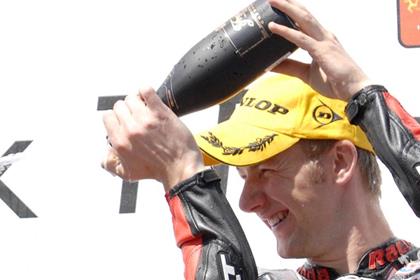 Hutchinson celebrates his victory in the Isle of Man TT junior Supersport race