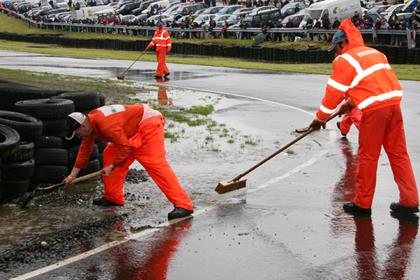 Marshalls try to sweep away the rain at Knockhill