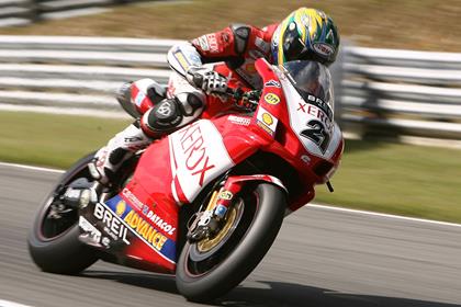 Troy Bayliss pipped britian's James Toseland to pole by 0.028seconds