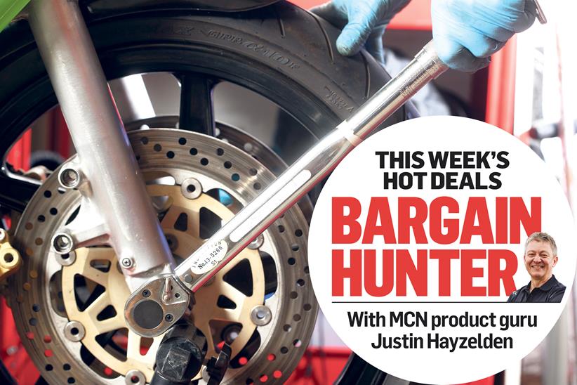 Tightening the front axle bolt with a torque wrench, with MCN's Bargain Hunter logo