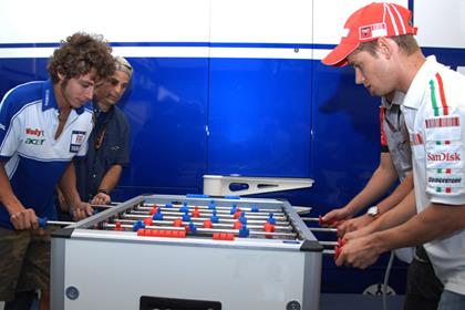 Valentino Rossi and Casey Stoner battle it out over a game of table football