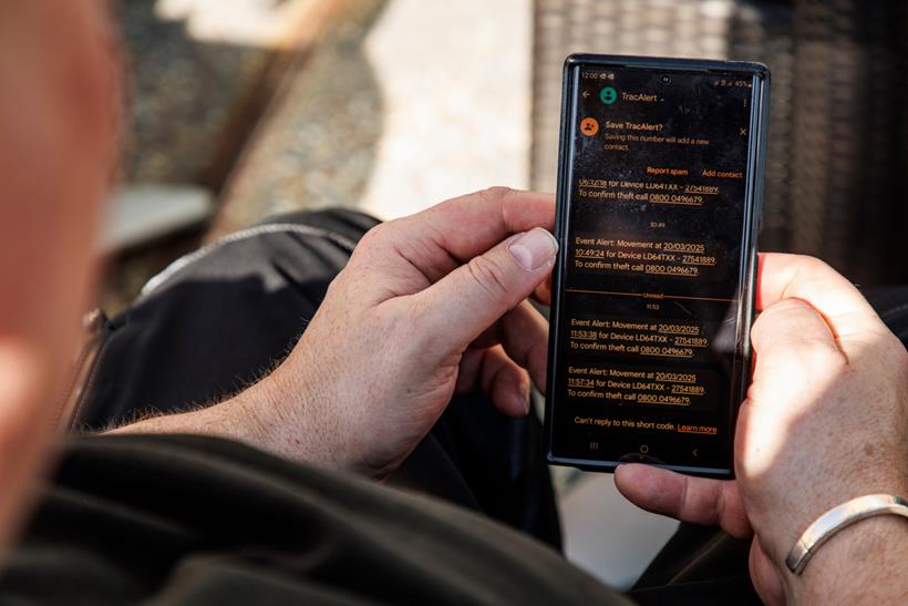 Person looking at movement alerts of motorcycle tracker