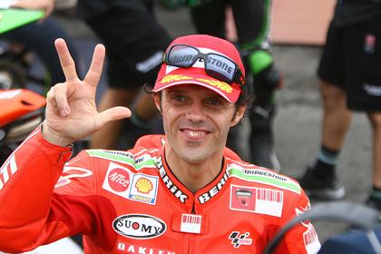 Loris Capirossi congratulates team-mate Casey Stoner on winning MotoGP crown