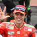 Loris Capirossi congratulates team-mate Casey Stoner on winning MotoGP crown