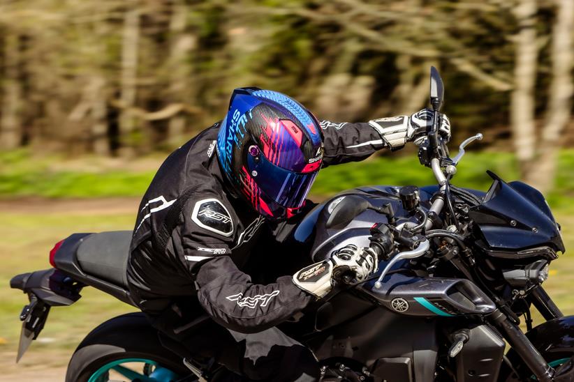 Rider cornering wearing a Shark Aeron