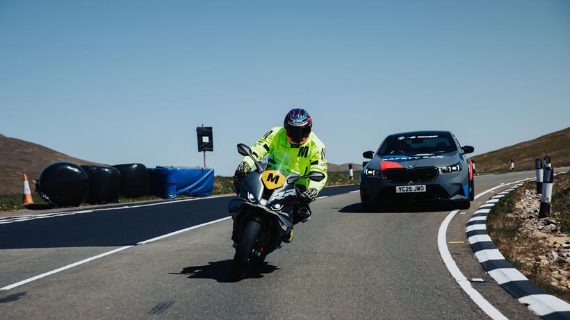 BMW S1000RR and BMW car on TT course