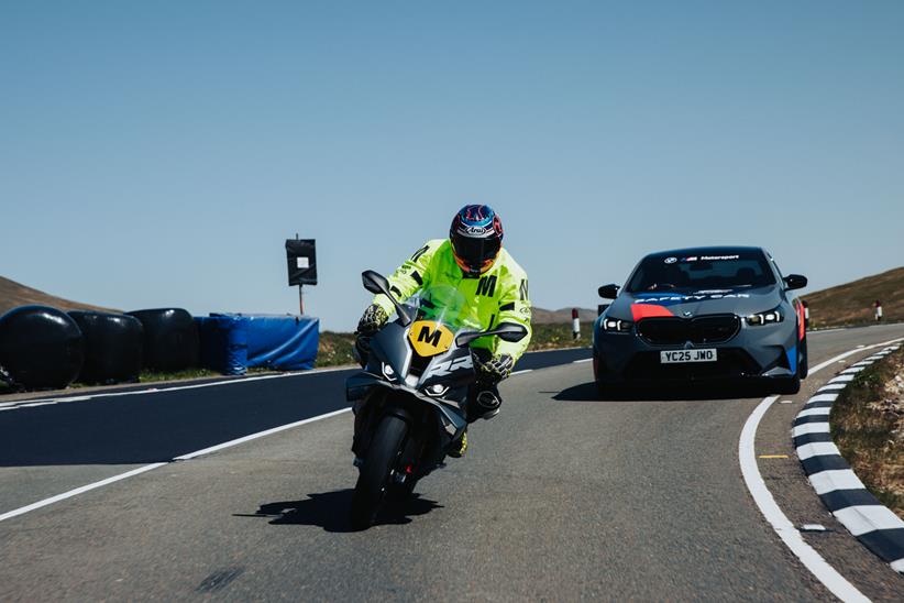 BMW S1000RR and BMW car on TT course