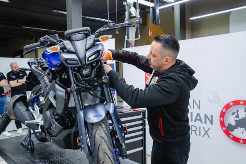 Liam Coffey working on a Yamaha MT-125