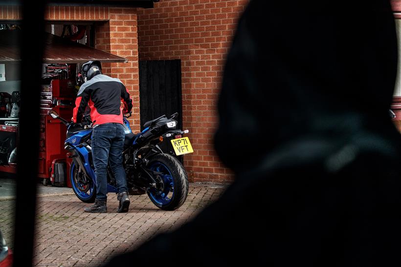 A motorcycle thief scoping out a garage