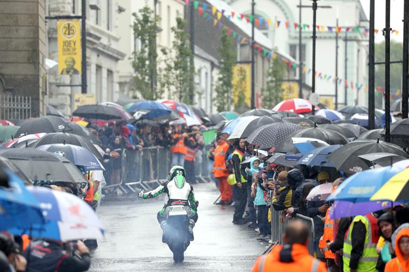 Crowds stay for the parade through the town despite the rain