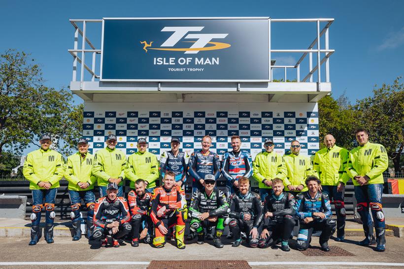 RST TT riders and travelling marshals in front of the podium