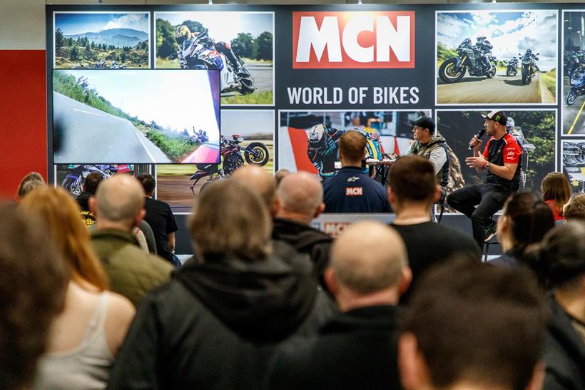 Crowds watch a narrated lap of the TT course