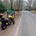 Motorcycle by The New Forest sign post on side of road