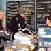 Couple of customers ordering from menu board in the Yondermann Café