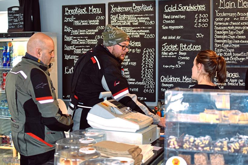Couple of customers ordering from menu board in the Yondermann Café 